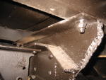 8001 - Rear of frame, note welds and cuts that are non original, but
original bracket is there, riveted to frame.  Upper right 